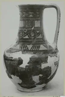 Painted pottery jug with a single loop handle and geometric bands, from Milia.
