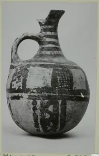 Pottery White Painted jug from Milia with dark painted bands and panels on a pale body
