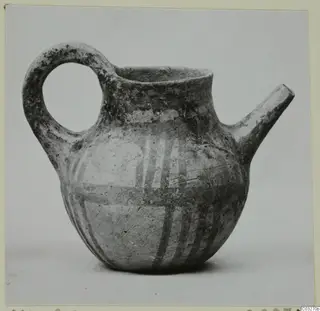 Pottery juglet with a loop handle, a spout and painted white bands on a dark body