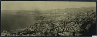 Panoramic view over a coastal bay and dry scrubby hills at Vouni