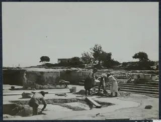 Workers laying a concrete floor over a cistern in Room 47 at Vouni