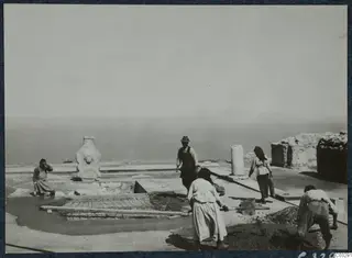 Workers covering the cistern in Room 47 at Vouni Palace with wire mesh and concrete, sea and hills behind