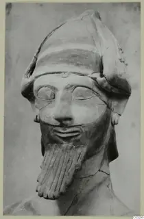 Terracotta head and bust of a bearded figure in a tall cap, Proto-Cypriote II