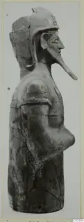 Terracotta figure in side profile with a helmet-like headdress and a long projecting face, from Ayia Irini