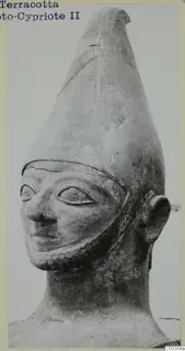 Terracotta head with a tall conical headdress, almond-shaped eyes and a row of round impressions along the jaw
