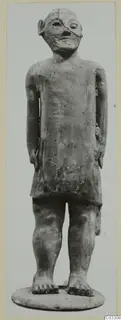 Standing terracotta figure of a Proto-Cypriote type from Ayia Irini, arms at its sides, on a round base