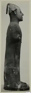 Standing terracotta statue in side profile, arm bent across the chest, on a flat base, Terracotta Proto-Cypriote II