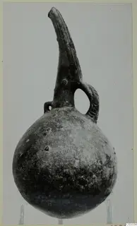Red Polished III jug from the Vrysi tou Barba tombs at Lapithos, with a tall spout and strap handle