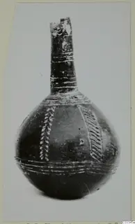 Black polished vessel with a tall narrow neck and light decorative bands, from Lapithos.