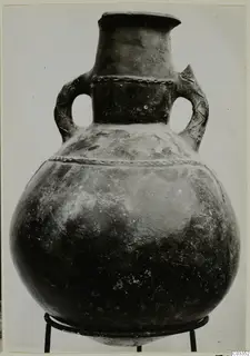 Pottery Red Polished III amphora with two loop handles, shown on a wire stand against a plain grey background
