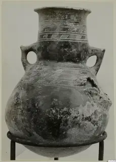 Red Polished III amphora with two loop handles and incised hatched bands, shown on a metal ring stand