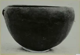 Pottery Red Polished II bowl from Lapithos, Vrysi tou Barba tombs, seen from the side against a pale background.