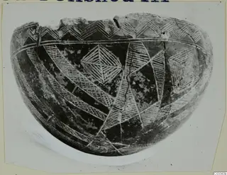 Pottery Red Polished III Bowl with incised hatched triangles, zigzags and bands, shown on a card mount