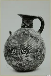 Pottery Red Polished II jug with a strap handle, a small lug and incised concentric circle and line decoration