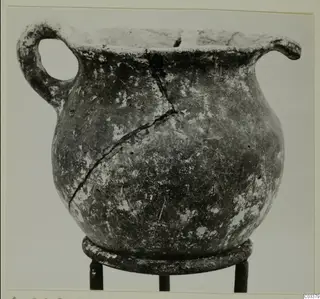 Pottery Red Polished III jug from Lapithos, with a single loop handle and a crack down its body