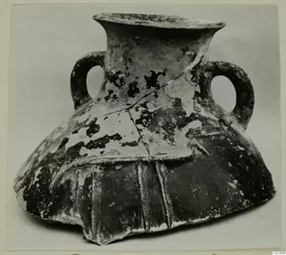 Red Polished II amphora from Lapithos with two loop handles and a flared rim, shown on a plain background