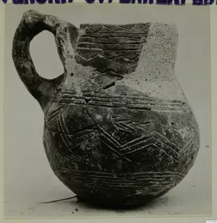 Pottery jug with a loop handle and incised bands and chevron patterns, from Lapithos