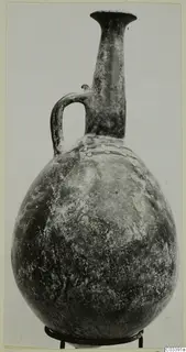 Jug with a tall neck, flared rim, single loop handle and a band of raised ornament on the shoulder, from Lapithos