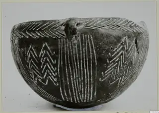 Red Polished III bowl from Lapithos, side view, with incised chevron and vertical line decoration
