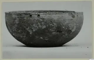 Plain white wheel-made bowl from Enkomi, shown from the side against a pale background.