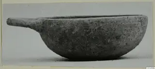 Pottery Plain White Wheel-made bowl with a short handle, seen from the side