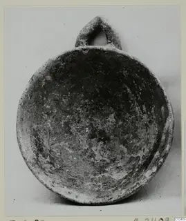 Plain white hand-made ware bowl with a loop handle, from Enkomi