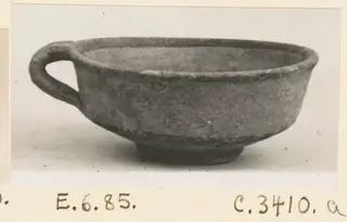 Bowl-jar with a single loop handle, shown in side view on a plain background