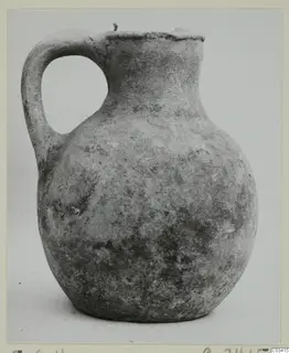 Round-bodied jug with a loop handle and a wide mouth, photographed against a plain background.