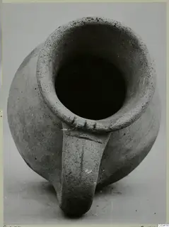 Pottery Plain White Wheel-made vessel with a single strap handle, seen from above
