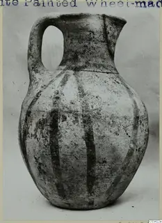White Painted Wheel-made jug with a strap handle and dark vertical bands on its body, from Enkomi