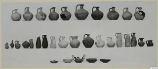 Rows of pottery jugs, bottles and bowls from Kountoura Trachonia, Tomb 2, arranged on a pale cloth
