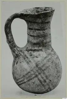 White Painted IV-V jug from Enkomi with a strap handle, bands on the neck and crossed diagonal lines on the body