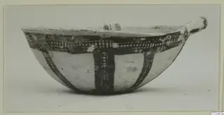 Pottery White Slip Ware bowl with dark cross-hatched painted bands and a small handle