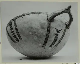 Pottery White Slip Ware vessel with a single handle and painted dark bands, from Enkomi