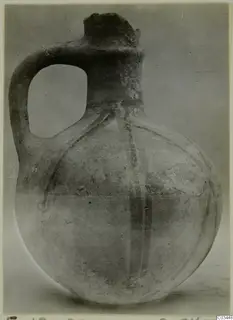 Round-bodied jug with a single loop handle and a tall neck, with dark painted bands on its body.
