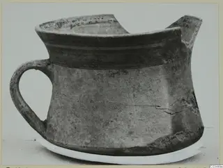 Pottery bowl-jar from Enkomi with a strap handle and a spout, shown from the side.