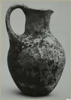 Black Slip Ware jug with a single loop handle and a flaring rim, from Enkomi.