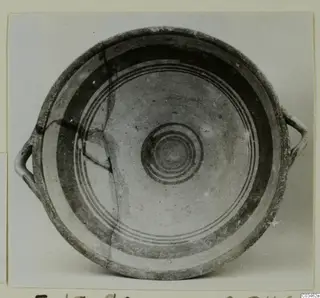 Bowl-jar with two loop handles and concentric painted circles inside, photographed from above.