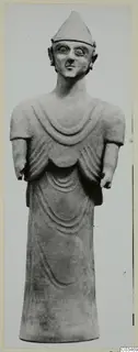 Terracotta Proto-Cypriote I, a standing figure with a conical cap, large round eyes and a long robe