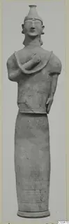Terracotta standing figure with a tall headdress and one arm bent across the chest, from Ayia Irini