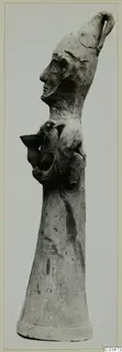 Terracotta Minor Plastic 3 from Ayia Irini: a tall clay object with a head in profile and a small clinging figure on its side.