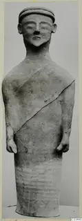 Terracotta standing figure from Ayia Irini, seen from the front against a grey backdrop