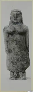 Standing limestone figure, catalogued as Neo-Cypriote, shown frontally against a plain grey background