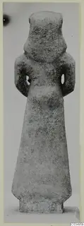 Limestone Neo-Cypriote figure, a standing statue seen from the front against a plain grey background.