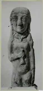 Terracotta figure of a standing figure with long hair, a necklace and one arm bent across the chest