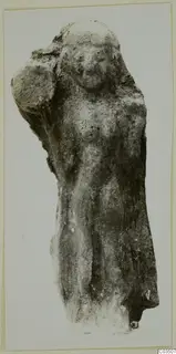 Terracotta figurine of a standing figure with one arm raised to the head and a worn, encrusted surface