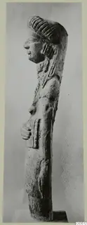 Terracotta figure seen in profile, facing left, with ridged hair and one hand on its abdomen.
