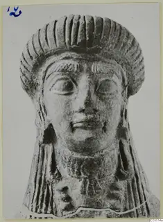 Terracotta head of a figure with ridged hair, seen from the front