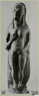 Terracotta figurine of a standing nude female figure, hands raised to the chest and lower body