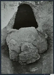 Excavated opening in a rock or earth face at Stylli, with large stones fallen in front of it